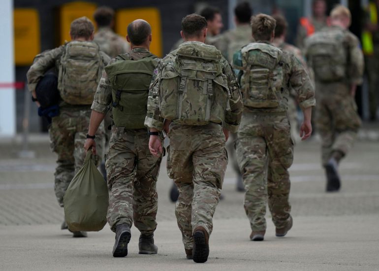 BRIZE NORTON, ENGLAND - AUGUST 28: Members of the British armed forces 16 Air Assault Brigade walk to the air terminal after disembarking a Royal Airforce Voyager aircraft at Brize Norton as they return from helping in operations to evacuate people from Kabul airport in Afghanistan on August 28, 2021 in Brize Norton, England. More than 100,000 people have been safely evacuated through the Kabul airport, according to the U.S., but thousands more are struggling to leave in one of history's biggest airlifts. (Photo by Alastair Grant-WPA Pool/Getty Images)