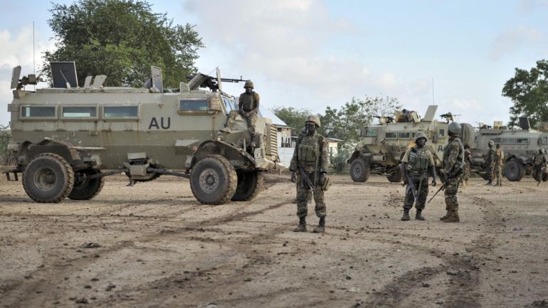 In this photo taken Sunday, Aug. 31, 2014 and provided by the African Union Mission to Somalia (AMISOM) Monday, Sept. 1, 2014, African Union (AU) soldiers from Uganda gather in the town of Kurtunwarey in Somalia. Somali government and AU troops have been engaging al-Shabab militants as part of their military offensive dubbed "Indian Ocean" aiming to oust al-Shabab from its last major hideouts in the southern parts of the Horn of Africa nation. (AP Photo/AMISOM, Tobin Jones)