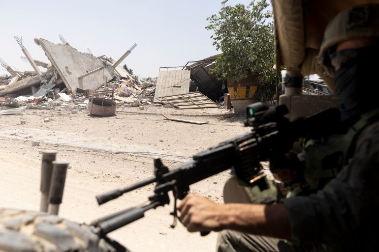 KHAN YUNIS, GAZA - JUNE 8: (EDITOR'S NOTE: Image has been reviewed by Israeli Defense Forces prior to transmission) An Israeli soldier guards as he sits in an army vehicle while escorting members of the press towards Gaza European Hospital near Khan Yunis on June 8, 2025 in Khan Yunis, Gaza. According to the Israeli military, it struck Hamas "underground infrastructure" beneath the European Hospital on May 13, reportedly killing Hamas chief Muhammad Sinwar, younger brother of the militant group's former leader, Yahya Sinwar, who was killed by Israeli forces last year. The Hamas-run civil defence said that during the strike six bombs hit the hospital's inner courtyard and surrounding area, killing 28 people and injuring dozens more. The IDF alleges tunnels under the European Hospital in southern Gaza were used by Hamas as a command center during the October 7, 2023 Hamas attack on Israel, masterminded by Yahya Sinwar. Hamas has not yet confirmed or denied Muhammad Sinwar's death. (Photo by Amir Levy/Getty Images)