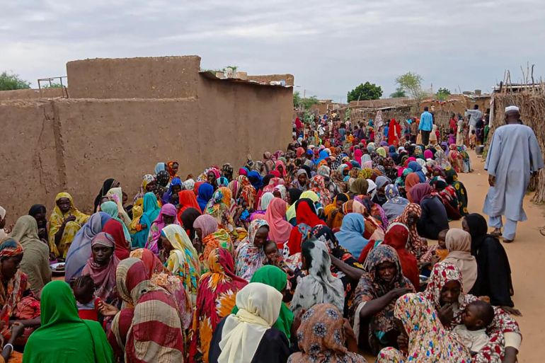 Sudanese residents gather to receive free meals in Al Fasher, a city besieged by Sudan's paramilitary Rapid Support Forces (RSF) for more than a year, in Darfur region, on August 11, 2025.