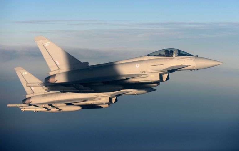تركيا ومقاتلة "اليوروفايتر" التي تعيد رسم خرائط السماء 1 British Royal Air Force's Typhoon Eurofighter jets demonstrate the interception of a Belgian air force transport plane as they fly over Britain