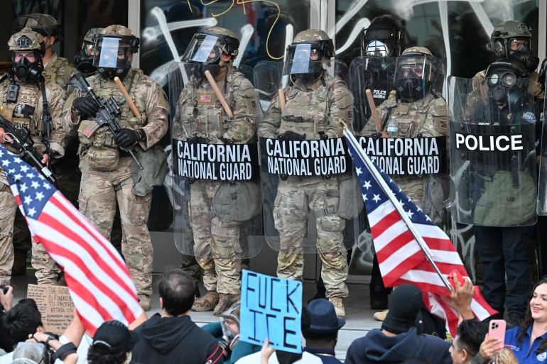 صحف أميركية: سيطرة ترامب على واشنطن توسع سيطرة الجيش وتهدد الديمقراطية 4 California National Guard and US Customs and Border Protection watch demonstrators gather in front the Federal Building before curfew goes in effect following days of protests in response to federal immigration operations in Los Angeles on June 10, 2025.