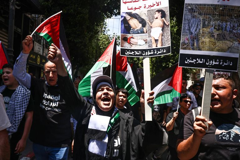 Demonstrators raise placards bearing pictures, during a protest in solidarity with the people of the Gaza Strip and Palestinian detainees, in the occupied-West Bank city of Ramallah on August 3, 2025. (Photo by Zain JAAFAR / AFP)