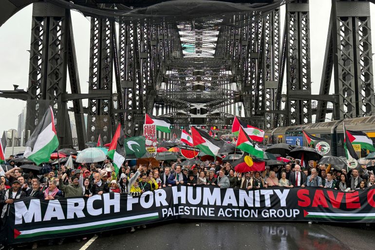 Thousands of protesters walk across the Sydney Harbour Bridge during the Palestine Action Group's March for Humanity in Sydney, Sunday, August 3, 2025. (Dean Lewins/AAP Image via AP)