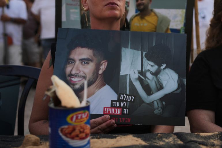أبرز الصور في أسبوع.. غزة تحت حصار الموت ومظاهرات العالم تفضح التجويع 15 A woman holds a photo of Israeli hostage Evyatar David, showing him before and during his captivity in the Gaza Strip, at a rally calling for the release of all hostages held by Hamas and an end to the ongoing war, in Tel Aviv, Israel, Saturday, Aug. 9, 2025. (AP Photo/Ohad Zwigenberg)