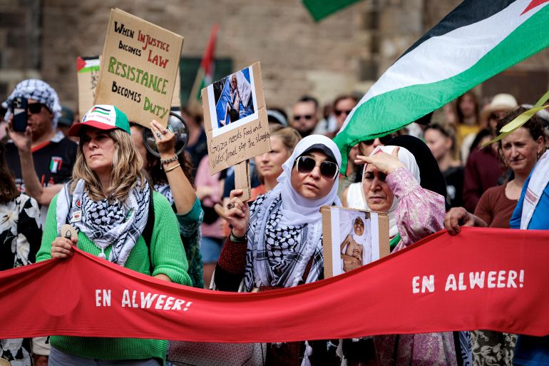 epa12281848 Protesters hold placards and Palestinian flags on Domplein during a demonstration against hunger and the many deaths in Gaza, in Utrecht, the Netherlands, 03 August 2025. The rally was organized by the Palestinian community in the Netherlands. EPA/RAMON VAN FLYMEN