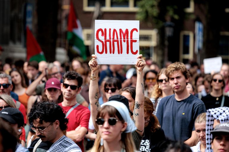 epa12281849 A protester holds up a sign on Domplein during a demonstration against hunger and the many deaths in Gaza, in Utrecht, the Netherlands, 03 August 2025. The rally was organized by the Palestinian community in the Netherlands. EPA/RAMON VAN FLYMEN