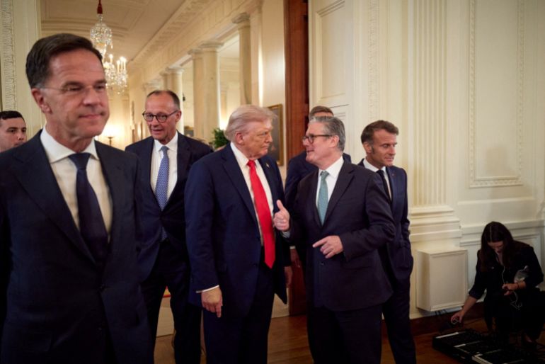 U.S. President Donald Trump talks with British Prime Minister Keir Starmer next to French President Emmanuel Macron, NATO Secretary General Mark Rutte and German Chancellor Friedrich Merz as they walk during a meeting, amid negotiations to end the Russian war in Ukraine with Ukrainian President Volodymyr Zelenskiy (not pictured), at the White House in Washington, D.C., U.S., August 18, 2025. Ukrainian Presidential Press Service/Handout via REUTERS ATTENTION EDITORS - THIS IMAGE HAS BEEN SUPPLIED BY A THIRD PARTY.