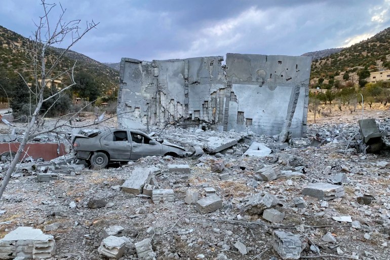 A damaged car is seen next to a destroyed building in the aftermath of an Israeli airstrike that targeted the eastern Lebanese village of Zeghrine in the Hermel area on November 10, 2024, amid the ongoing war between Israel and Hezbollah. - A wave of Israeli strikes on east and south Lebanon on November 9 killed at least 33 people, the health ministry said, as Israel intensified its air campaign against Iran-backed Hezbollah. (Photo by Sam SKAINEH / AFP)