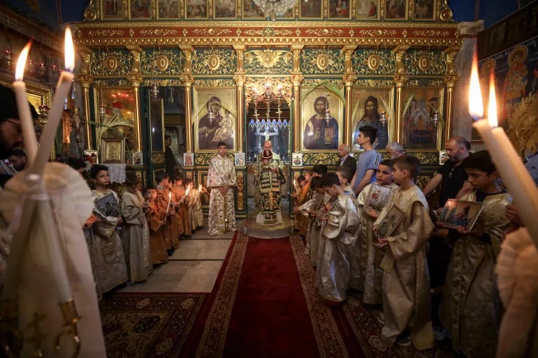 Palestinian Christians hold Palm Sunday Mass at the Greek Orthodox Saint Porphyrius Church in Gaza City on April 28, 2024 [Dawoud Abu Alkas/Reuters]