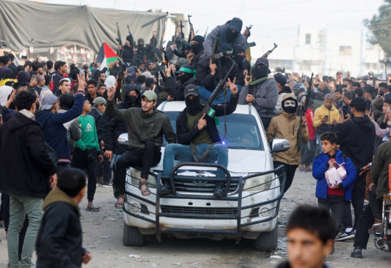 Palestinian militants celebrate despite a delay in the ceasefire between Israel and Hamas over the hostage list, in Khan Younis in the southern Gaza Strip, January 19, 2025. REUTERS/Mohammed Salem