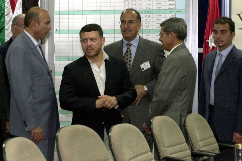 إخوان الأردن والنظام.. 80 عاما من علاقة متقلبة 3 Jordan's King Abdullah II (2nd L) and his half brother Ali (R) arrive at the interior ministry in Amman to follow up voting procedures 17 June 2003. Voting in Jordan's first parliamentary polls since 1997 began across 45 constituencies to elect a 110-seat parliament, with six seats reserved for women. Also in the picture are Interior Minister Koftan Majali (3rd R), Royal Court Minister Faisal al-Fayez (2nd R) and Chief of the Royal Court Yussef Dalabih (L). AFP PHOTO/KHALIL MAZRAAWI (Photo by KHALIL MAZRAAWI / AFP)