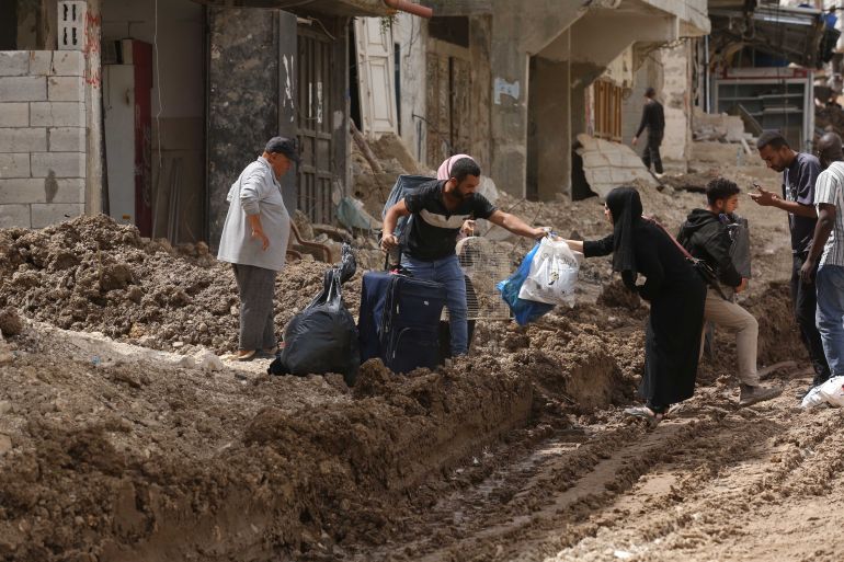 TULKARM, WEST BANK - MAY 02: Palestinians rush to their homes, to take what they could carry and left the area, on May 02, 2025 in Tulkarm