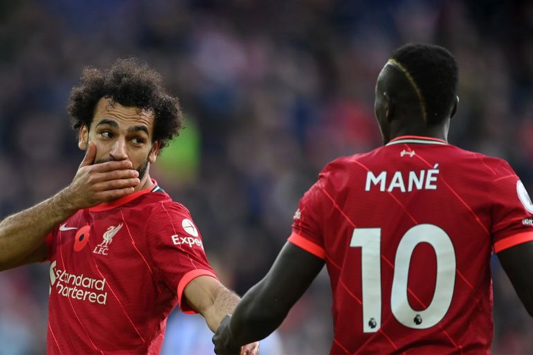 صلاح يكسر صمته عن علاقته المتوترة بماني ويرد على وصفه بأنه "أناني" 19 Mohamed Salah of Liverpool talks with team mate Sadio Mane during the Premier League match between Liverpool and Brighton & Hove Albion at Anfield on October 30, 2021 in Liverpool, England. (Photo by Shaun Botterill/Getty Images)