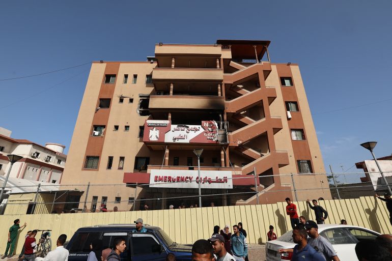 بالصور.. مستشفى ناصر الطبي يُقصف بمرضاه 24 People and traffic pass the fence of the Nasser hospital in Khan Yunis which was hit in an Israeli strike at dawn that targeted the southern Gaza Strip city on May 13, 2025.
