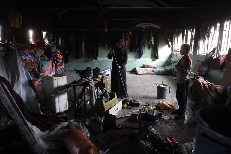 إسرائيل أحرقت النازحين نياما في مجزرة حي الدرج 25 A Palestinian woman sweeps the floor inside a classroom after an Israeli airstrike hit the Mussa bin Nusseir UNRWA school, serving as a shelter for people who left their homes in the besieged Palestinian territory, in Gaza City's Daraj district on May 20, 2025.