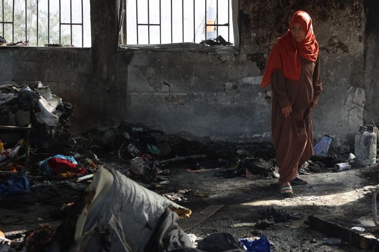 إسرائيل أحرقت النازحين نياما في مجزرة حي الدرج 21 A Palestinian woman stands amid burnt items inside a classroom after an Israeli airstrike hit the Mussa bin Nusseir UNRWA school, serving as a shelter for people who left their homes in the besieged Palestinian territory, in Gaza City's Daraj district on May 20, 2025.