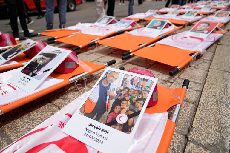 بالصور.. طواقم الهلال الأحمر تطالب بالحماية وسط غياب العدالة في غزة 21 Posters with names and pictures of fallen paramedics during a symbolic funeral for 48 Palestinian Red Crescent Society members who lost their lives in the line of humanitarian duty during the Israel Hamas war in Gaza, according to a PRCS statement, marking the World Day of Red Cross and Red Crescent, in the West Bank city of Ramallah Monday, May 12, 2025. (AP Photo/Nasser Nasser)