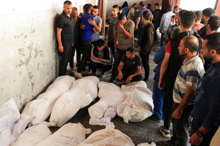 إسرائيل أحرقت النازحين نياما في مجزرة حي الدرج 20 Mourners react next to the bodies of Palestinians killed in Israeli strikes, during the funeral at Al-Ahli Arab Baptist hospital, in Gaza City, May 20, 2025. REUTERS/Dawoud Abu Alkas TPX IMAGES OF THE DAY