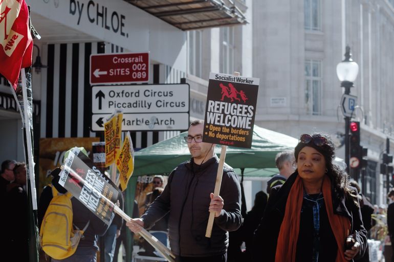 هاجس الأصوات الانتخابية يدفع حكومة ستارمر إلى اليمين 19 London, UK - 03 19 2022: A man protester at Portland Place holding a sign, Socialist Worker… Refugees Welcome…’, for the yearly ‘March Against Racism’, held around ‘UN Anti Racism Day’.; Shutterstock ID 2140670613; purchase_order: AJA; job: ; client: ; other: