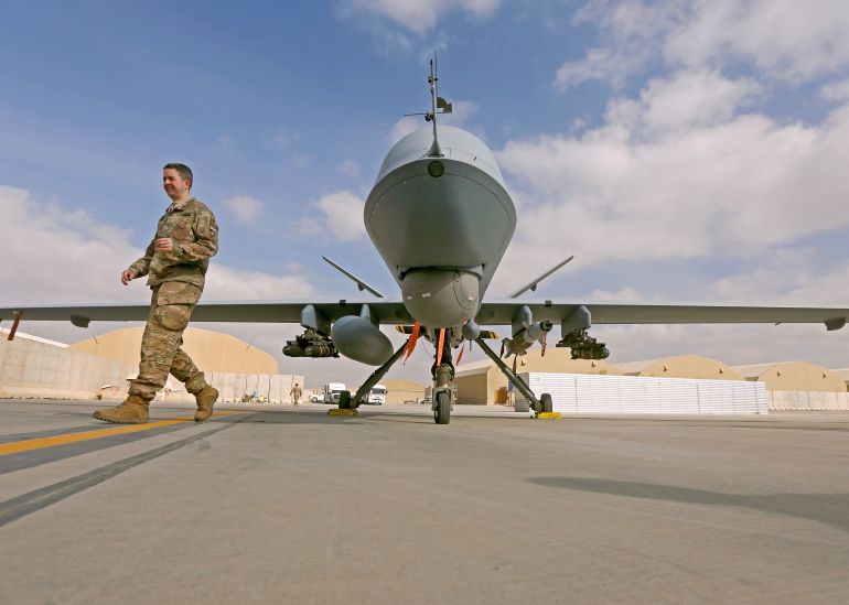 المسيّرة الأميركية الأقوى تحتضر وهذه هي الأسباب 2 U.S. service member passes in front of a MQ-9 Reaper drone, one of a squadron that has arrived to step up the fight against the Taliban, at the Kandahar air base, Afghanistan January 23, 2018. REUTERS/Omar Sobhani