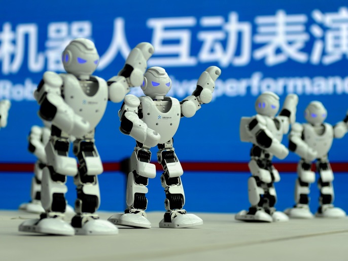 الذكاء الاصطناعي في التحكيم الرياضي بين الدقة والتحديات 1 Humanoid robots developed by UBTECH perform a synchronised dance at the World Intelligent Manufacturing Summit in Nanjing, Jiangsu province, China December 7, 2017. REUTERS/Stringer ATTENTION EDITORS - THIS IMAGE WAS PROVIDED BY A THIRD PARTY. CHINA OUT.