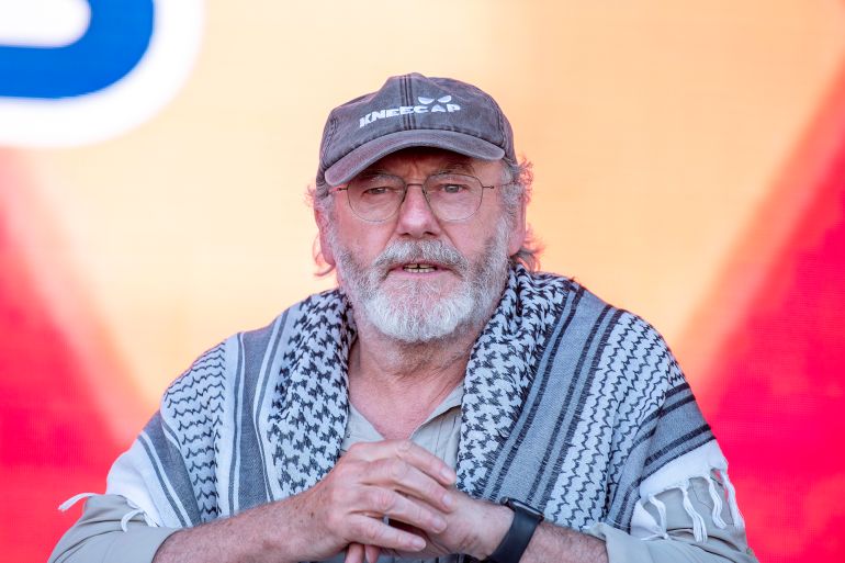 CATANIA, ITALY - MAY 31: Liam Cunningham, actor and activist, during his public speech, wearing a Palestinian keffiyeh and a cap, he appears thoughtful and intense, reflecting his commitment and solidarity with the cause he advocates for on May 31, 2025 in Catania, Italy. Swedish activist Greta Thunberg is among those who will attempt to sail to Gaza on a boat organized by the Freedom Flotilla Coalition (FFC), in a bid to break Israel's blockade of the Palestinian territory. Freedom Flotilla had to abort a previous journey in early May after it said its boat came under attack by drones in international waters near Malta. (Photo by Fabrizio Villa/Getty Images)