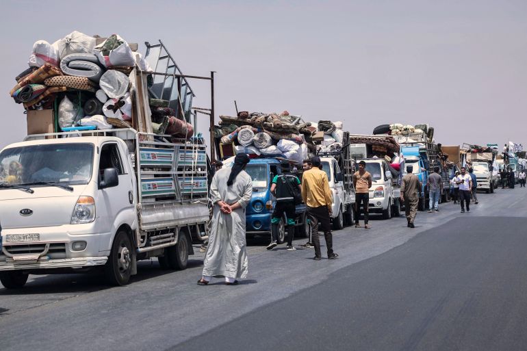 نيويورك تايمز: رحلة عبر مدن سوريا بعد التحرير 6 Trucks carrying around 60 displaced families gather on the highway as they head to their village, Kafr Sijna, after more than five years in the Atmeh camps near the Syrian-Turkish border, on a highway north of Kafr Sijna, Syria, Sunday, May 18, 2025. (AP Photo/Ghaith Alsayed)