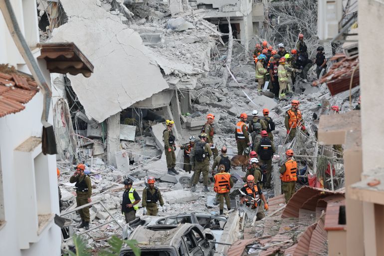 ضربة إيرانية مباشرة في ريشون ليتسيون تثير صدمة في إسرائيل 2 epa12174523 Israeli rescue teams at the site where Iranian ballistic missiles hit residential buildings in Rishon LeZion, near Tel Aviv, Israel, 14 June 2025. An Israeli Defense Forces (IDF) spokesperson said Iran launched a wave of ballistic missiles toward Israel, and according to emergency service Magen David Adom (MDA), 21 people were injured, including two in critical condition. EPA-EFE/ABIR SULTAN