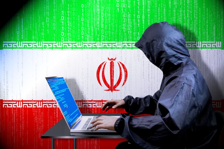 خبايا صراع الظلام بين إسرائيل وإيران 1 Anonymous hooded hacker, flag of Iran, binary code - cyber attack concept