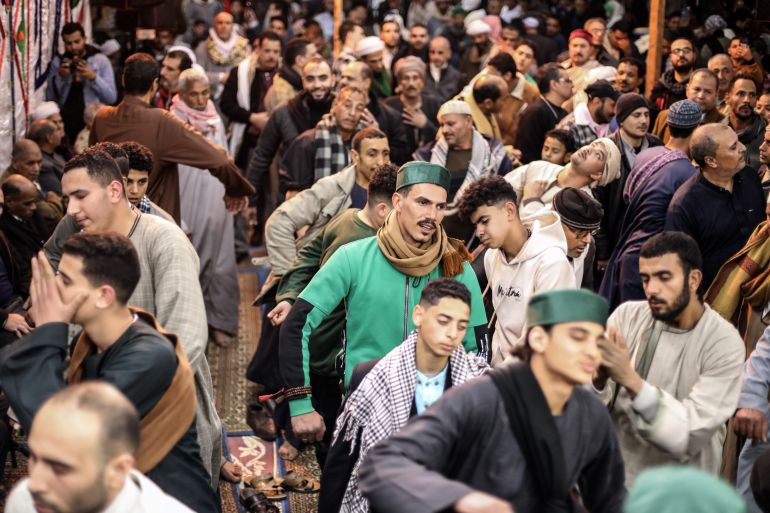 انتخابات الصوفية بمصر.. تجديد بالقيادة وانتظار لبعث الدور الغائب 2 صوت المدائح والتواشيح لا تتوقف في محيط مسجد "السيدة زينب"، في حي شهير يحمل ذات الاسم وسط القاهرة، وتذوب عشقا بين حشود كبيرة تتمايل وتنطق بعبارات في حب النبي محمد (ص) وآل بيته. تلك الأجواء والطقوس الصوفية التراثية، تعرفها مصر في الثلاثاء الأخير من شهر "رجب" بالتقويم الهجري من كل عام، احتفاء بالليلة الختامية لـ "مولد السيدة زينب"، أحد أكبر وأشهر مساجد القاهرة، والذي ينسب إلى حفيدة النبي زينب بنت علي بن أبي طالب. ( Mohamed Elshahed - وكالة الأناضول )