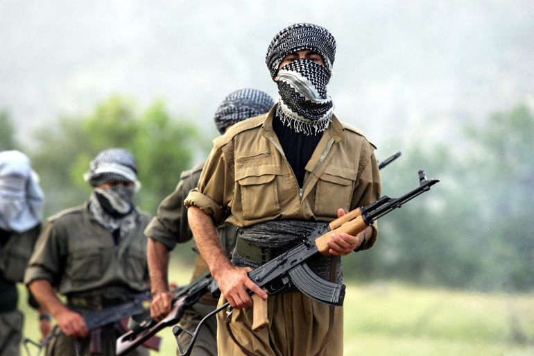A PKK (Kurdistan Workers Party) fighter jog during an early morning training session, 20 June 2007 at the Amedia area in Northern Iraq, 10 km near the Turkish border. Turkey declared several areas near the border with Iraq to be 'temporary security zones' in a sign of increasing activity in its campaign against Kurdish rebels. AFP PHOTO/MUSTAFA OZER (Photo by MUSTAFA OZER / AFP)