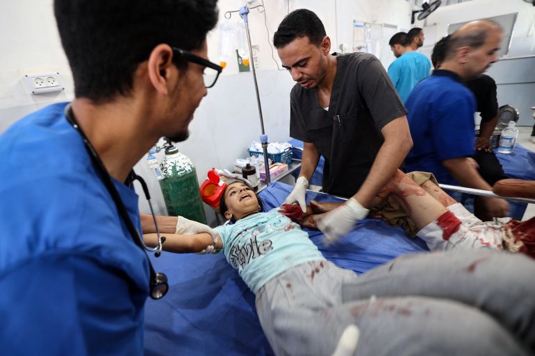 61 شهيدا في غزة والاحتلال يواصل استهداف المجوعين 1 TOPSHOT - A Palestinian girl reacts as she receives treatment for her injuries at the Al-Awda hospital in Nuseirat in the central Gaza Strip, following Israeli strikes on July 13, 2025.