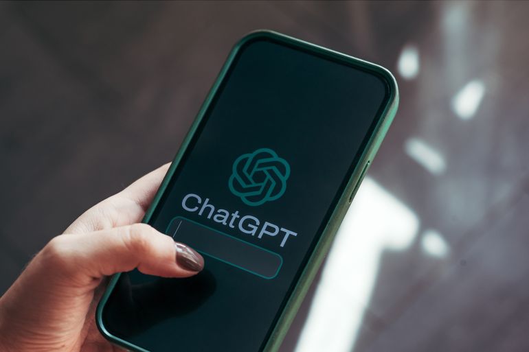 البروفيسور أديب-مقدم: الذكاء الاصطناعي وريث عنصرية الاستعمار والطبقية 5 woman's hand holding a smartphone with ChatGPT logo, on the screen. Chat GPT is an artificial intelligence chatbot application developed in 2022 by OpenAI; Shutterstock ID 2368379425; purchase_order: aj; job: ; client: ; other: