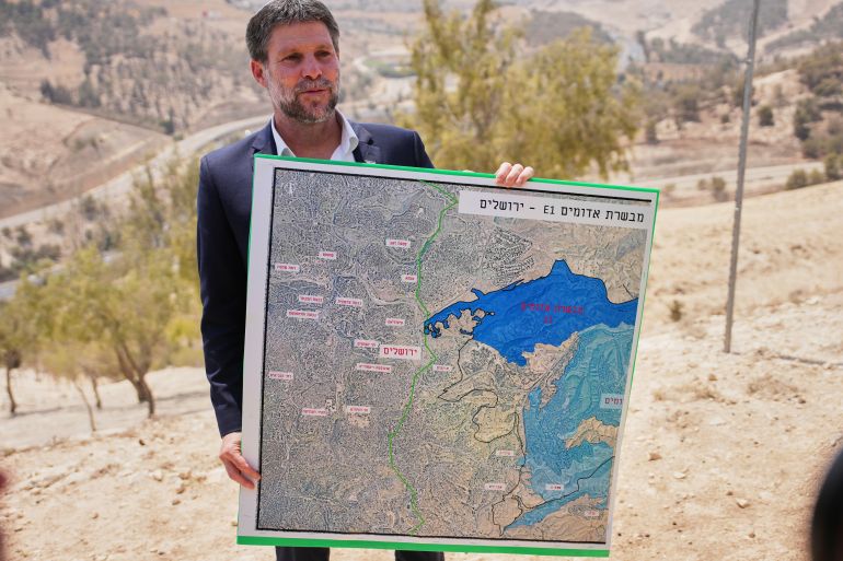 إصابة فلسطينيين برصاص مستوطنين بالخليل والاحتلال يصعد اعتداءاته 2 Israeli Finance Minister Bezalel Smotrich holds a map that shows the E1 settlement project during a press conference near the settlement of Maale Adumim, in the Israeli-occupied West Bank, Wednesday, Aug. 14, 2025. (AP Photo/Ohad Zwigenberg)