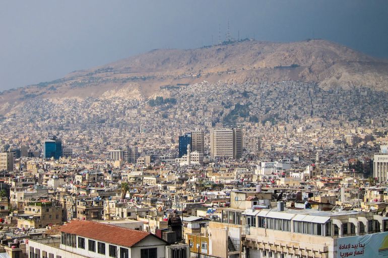 Wide shot of the city and Mount of Qasioun mountain in Damascus, Syria, 30/12/2019